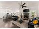 Spacious living room featuring a stone fireplace, large TV, and open-concept layout with bar seating at 2751 Pilgrim Mill Rd, Cumming, GA 30041