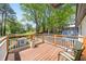 Inviting back deck with a scenic view and white railings, perfect for outdoor relaxation and entertaining at 308 Reed St, Scottdale, GA 30079