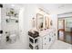 Charming bathroom featuring dual sinks, marble counters, and a view into an adjacent room at 308 Reed St, Scottdale, GA 30079