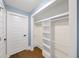 Organized walk-in closet featuring built-in shelving and hanging rods at 308 Reed St, Scottdale, GA 30079