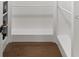 Walk-in closet with wooden floors, integrated shelves, and hanging storage at 308 Reed St, Scottdale, GA 30079