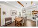 Elegant dining area with a wooden table and chairs, complemented by modern lighting fixtures at 308 Reed St, Scottdale, GA 30079