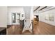 Inviting entryway with hardwood floors, staircase, and views into the spacious living room with beautiful beam ceilings at 308 Reed St, Scottdale, GA 30079