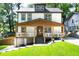 Charming two-story home with a welcoming covered front porch and well-maintained lawn at 308 Reed St, Scottdale, GA 30079