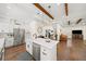 Open kitchen featuring an island, stainless steel appliances, and seamless access to the living area at 308 Reed St, Scottdale, GA 30079