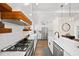 Contemporary kitchen equipped with stainless steel appliances, white cabinets, and stylish pendant lighting at 308 Reed St, Scottdale, GA 30079