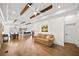Open-concept living space with hardwood floors, exposed beams, and abundant natural light at 308 Reed St, Scottdale, GA 30079