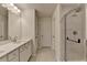 Bathroom with double vanity, granite countertops, tile floors, and glass-enclosed shower at 3587 Hidden Valley Cir, Lawrenceville, GA 30044