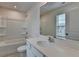 A well-lit bathroom featuring a toilet, shower, vanity, and a large mirror at 3587 Hidden Valley Cir, Lawrenceville, GA 30044