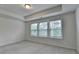 Bright bedroom with three windows, neutral carpet and walls, with tray ceiling, is move-in ready at 3587 Hidden Valley Cir, Lawrenceville, GA 30044