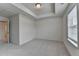 Spacious bedroom with tray ceiling, neutral carpet and walls, with natural light from one window at 3587 Hidden Valley Cir, Lawrenceville, GA 30044