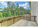 Wooden deck overlooking the backyard featuring wooden railings and partial privacy fence at 3587 Hidden Valley Cir, Lawrenceville, GA 30044