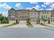Attractive townhouse exteriors featuring brick facade, garages, driveways, and tidy landscaping at 3587 Hidden Valley Cir, Lawrenceville, GA 30044