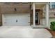 Inviting two-car garage, brick home with a charming entryway and black door at 3587 Hidden Valley Cir, Lawrenceville, GA 30044