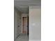Hallway with neutral carpet and walls, and three doors, is move-in ready at 3587 Hidden Valley Cir, Lawrenceville, GA 30044