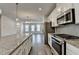 Stylish kitchen featuring stainless steel appliances, granite counters, and white cabinets, open floor plan at 3587 Hidden Valley Cir, Lawrenceville, GA 30044