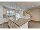 Open kitchen with granite island, stainless steel appliances, white cabinetry, and hardwood floors at 3587 Hidden Valley Cir, Lawrenceville, GA 30044