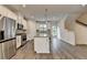 Spacious kitchen featuring stainless appliances, island with granite countertops, and stylish flooring at 3587 Hidden Valley Cir, Lawrenceville, GA 30044