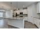 Modern kitchen features white cabinets, granite countertops, stainless steel appliances, and wood flooring at 3587 Hidden Valley Cir, Lawrenceville, GA 30044