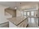 Large granite kitchen island with a view of the open-concept living area at 3587 Hidden Valley Cir, Lawrenceville, GA 30044