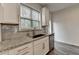 Bright kitchen with granite counters, white cabinets, stainless steel appliances, and stylish backsplash at 3587 Hidden Valley Cir, Lawrenceville, GA 30044