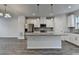 Bright kitchen features stainless steel appliances, granite countertops, and a large center island at 3587 Hidden Valley Cir, Lawrenceville, GA 30044