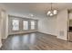 The well lit living room has hardwood floors and large windows that bring in natural light at 3587 Hidden Valley Cir, Lawrenceville, GA 30044