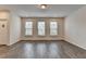 Open living room area featuring hardwood flooring, natural light, and neutral paint palette at 3587 Hidden Valley Cir, Lawrenceville, GA 30044