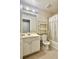 Neutral bathroom featuring a vanity and a shower with a patterned curtain at 5783 Poppy Tree Ln, Tucker, GA 30084