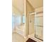 Bathroom featuring tile floors, jacuzzi tub, and walk-in shower with glass door at 5783 Poppy Tree Ln, Tucker, GA 30084