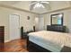 Spacious bedroom featuring hardwood floors, a ceiling fan, and ample closet space for optimal storage at 5783 Poppy Tree Ln, Tucker, GA 30084