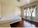 Bedroom featuring hardwood floors, natural light from large window, and ample closet space at 5783 Poppy Tree Ln, Tucker, GA 30084