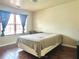 Bedroom featuring hardwood floors, natural light from large window, and ample closet space at 5783 Poppy Tree Ln, Tucker, GA 30084