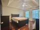 Spacious bedroom with hardwood floors, tray ceiling, and large windows at 5783 Poppy Tree Ln, Tucker, GA 30084