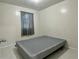 Simple bedroom with a bed frame and tile flooring at 5783 Poppy Tree Ln, Tucker, GA 30084