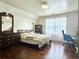 Bedroom featuring hardwood floors, natural light from large window, and desk with chair at 5783 Poppy Tree Ln, Tucker, GA 30084