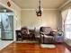 Cozy dining area with hardwood floors, an elegant chandelier, and a comfortable recliner by the window at 5783 Poppy Tree Ln, Tucker, GA 30084