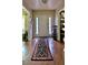 Welcoming foyer with gleaming hardwood floors and a stylish rug leading into the home at 5783 Poppy Tree Ln, Tucker, GA 30084