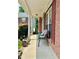 Inviting front porch with cozy seating, brick accents, and a glimpse of the home's charming exterior at 5783 Poppy Tree Ln, Tucker, GA 30084