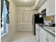 Bright kitchen featuring white appliances, cabinets, and tile flooring at 5783 Poppy Tree Ln, Tucker, GA 30084