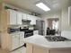 Bright kitchen featuring white cabinets and stainless steel appliances overlooking a cozy breakfast nook at 5783 Poppy Tree Ln, Tucker, GA 30084