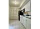 Efficient kitchen features white cabinetry, modern appliances, and tiled flooring at 5783 Poppy Tree Ln, Tucker, GA 30084