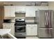 Bright kitchen with stainless steel appliances, a gas range, and white cabinetry at 5783 Poppy Tree Ln, Tucker, GA 30084