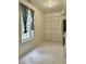 Kitchen space featuring stainless appliances, a window with curtains, and tiled flooring at 5783 Poppy Tree Ln, Tucker, GA 30084