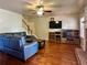 Comfortable living room boasts a fireplace, hardwood floors, and an entertainment center for modern living at 5783 Poppy Tree Ln, Tucker, GA 30084