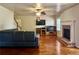 Spacious living room features a fireplace, hardwood floors, and a ceiling fan for comfortable living at 5783 Poppy Tree Ln, Tucker, GA 30084