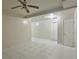 Living room with white tile flooring and a ceiling fan at 5783 Poppy Tree Ln, Tucker, GA 30084