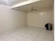 Spacious living room with white tile and a ceiling fan at 5783 Poppy Tree Ln, Tucker, GA 30084
