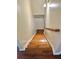 Hardwood staircase leading upstairs, with wooden railings and neutral walls at 5783 Poppy Tree Ln, Tucker, GA 30084