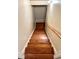 View of a hardwood staircase with wooden handrail at 5783 Poppy Tree Ln, Tucker, GA 30084
